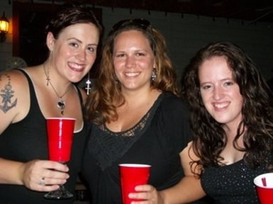 Three girls drinking out of red solo cups